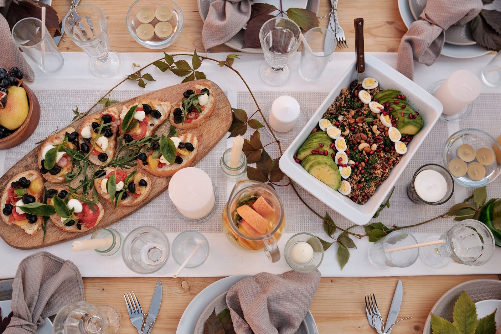Stylish dinner setup featuring bruschetta and quinoa salad with avocado and eggs, perfect for celebrations.