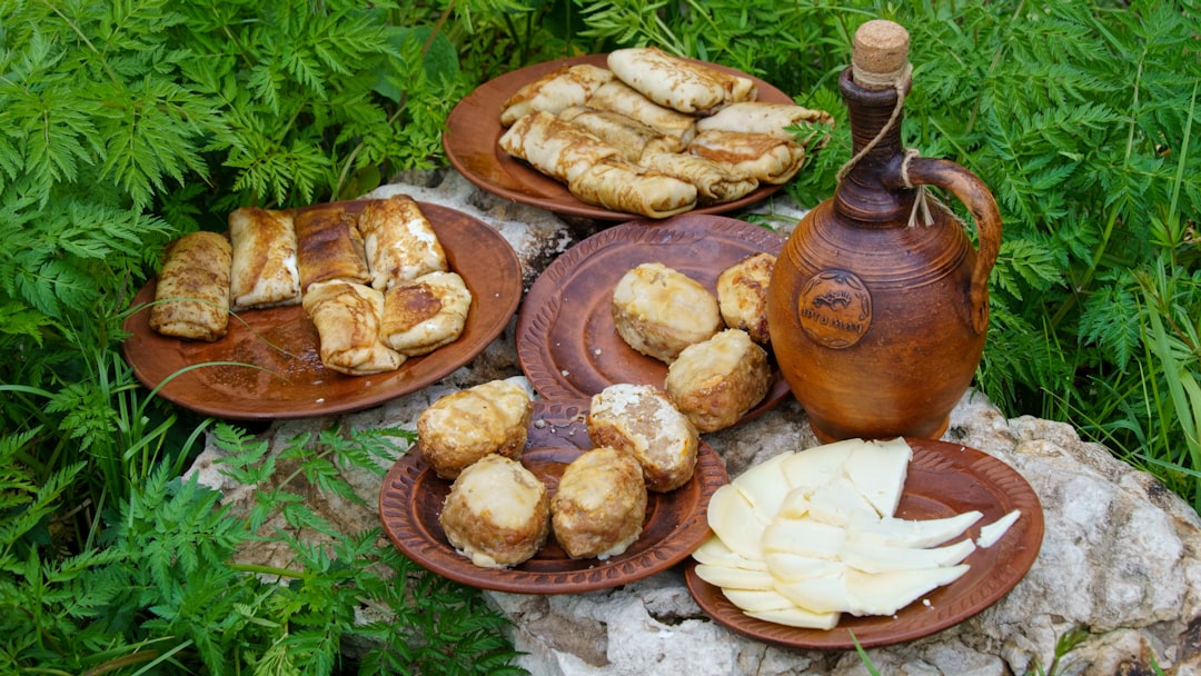 a table topped with plates of food and a tea pot
