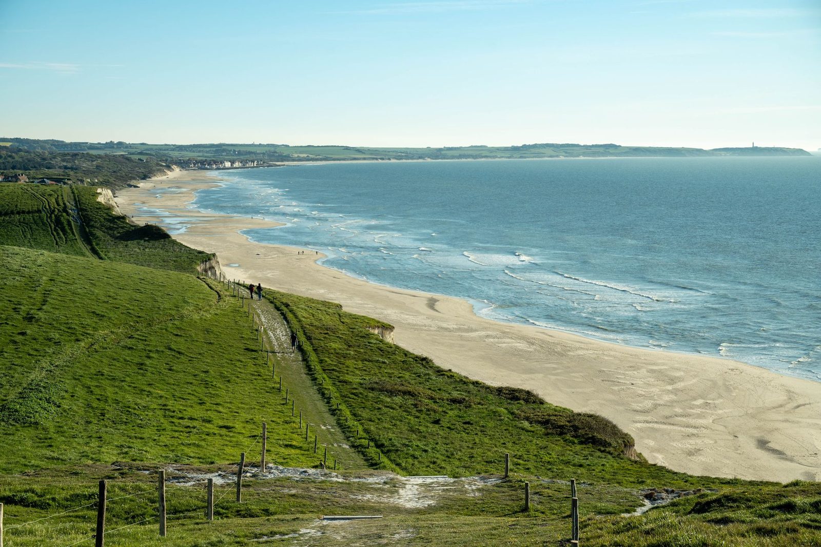 Stunning landscape of Escalles beach and coastline under clear blue sky.