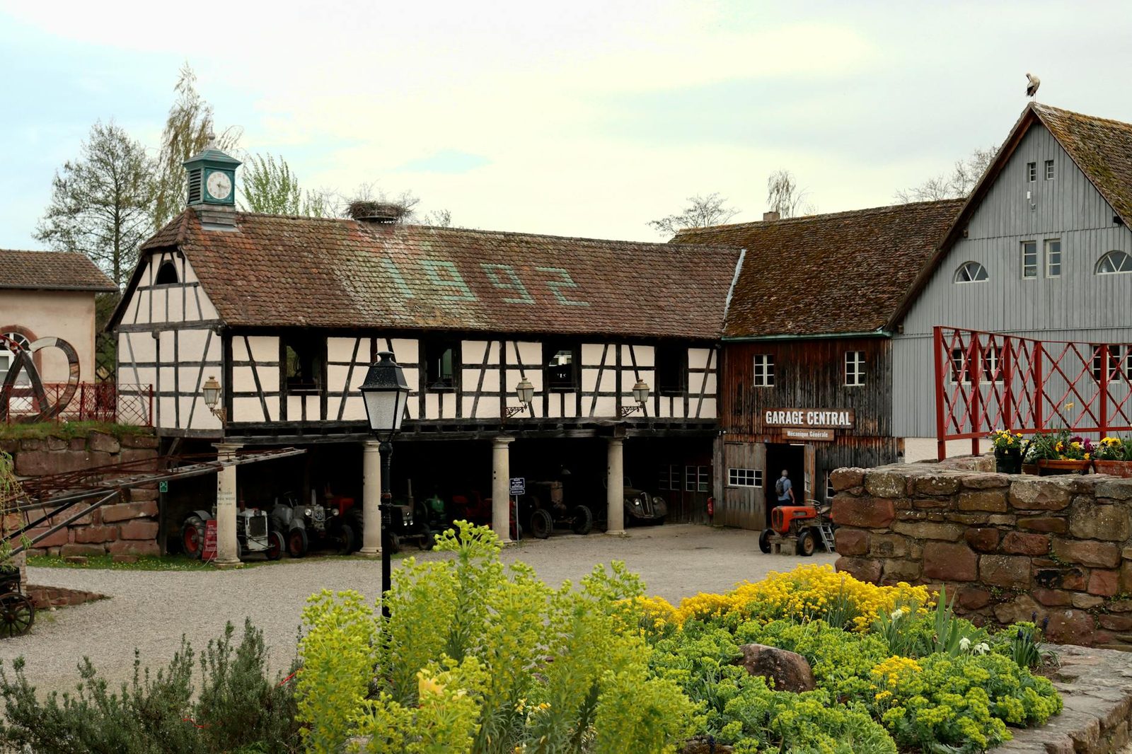 Historic farmhouse and garage at Écomusée d'Alsace in Ungersheim, featuring traditional Alsace architecture.