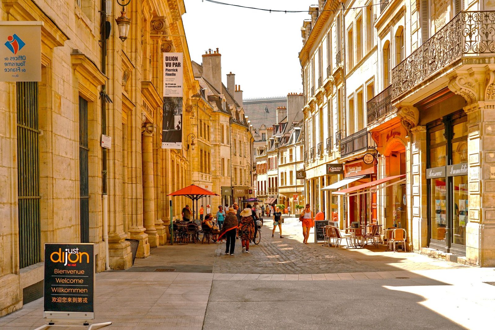 Picturesque street in Dijon, France, with vintage architecture and lively atmosphere.