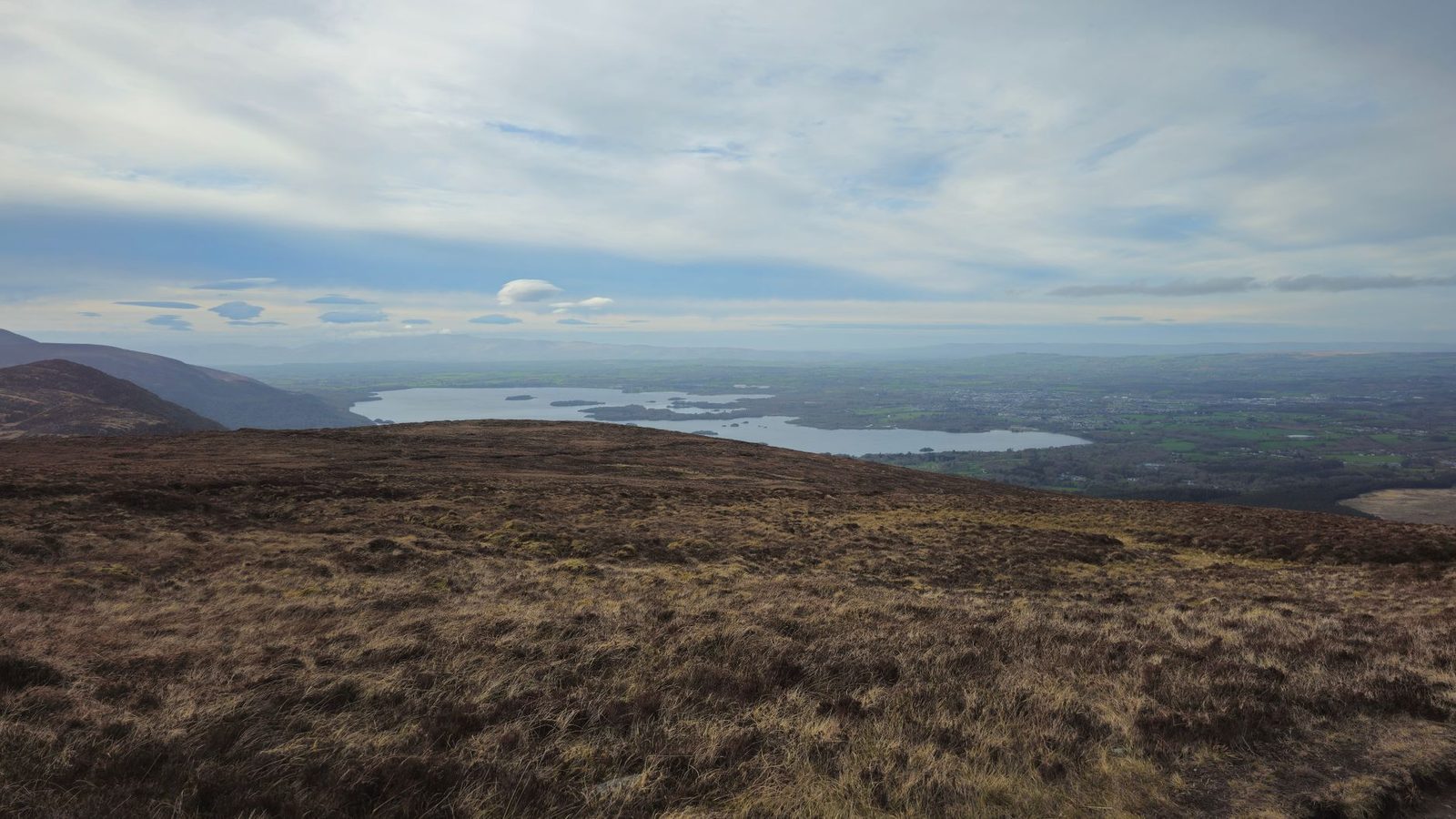 Breathtaking view over Killarney Lakes with dramatic skies and rolling hills in County Kerry, Ireland.