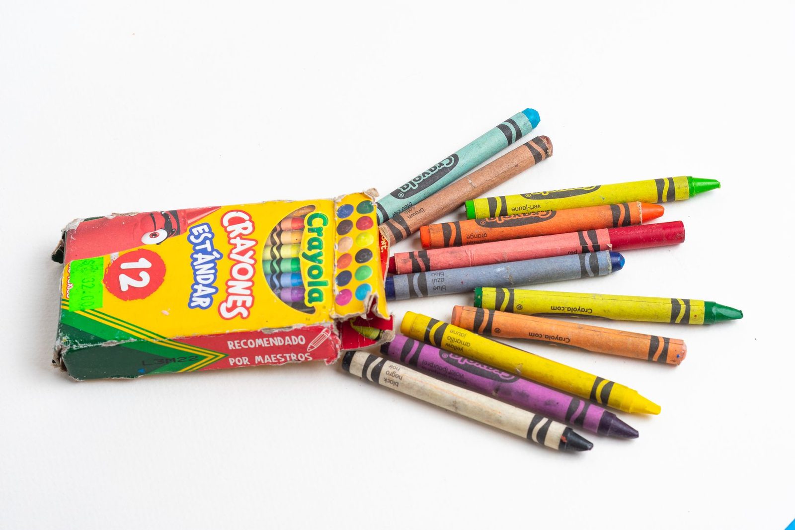 Open Crayola crayon box with colorful crayons on a white background.