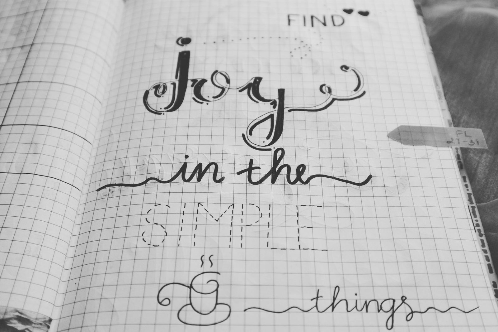 Black and white image of a handwritten inspirational quote on a notebook page.