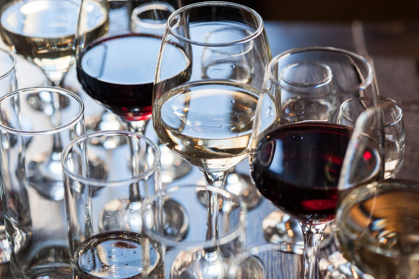 A variety of red and white wines elegantly displayed in glasses, capturing their rich colors and textures.