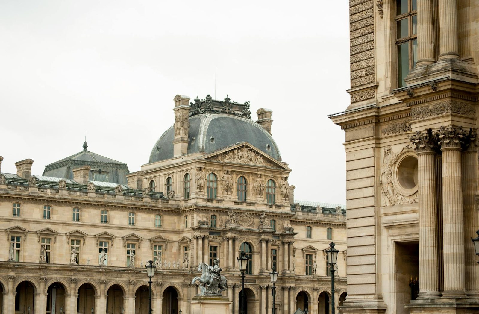 Elegant view of the Louvre Museum's historic architecture in Paris, France.