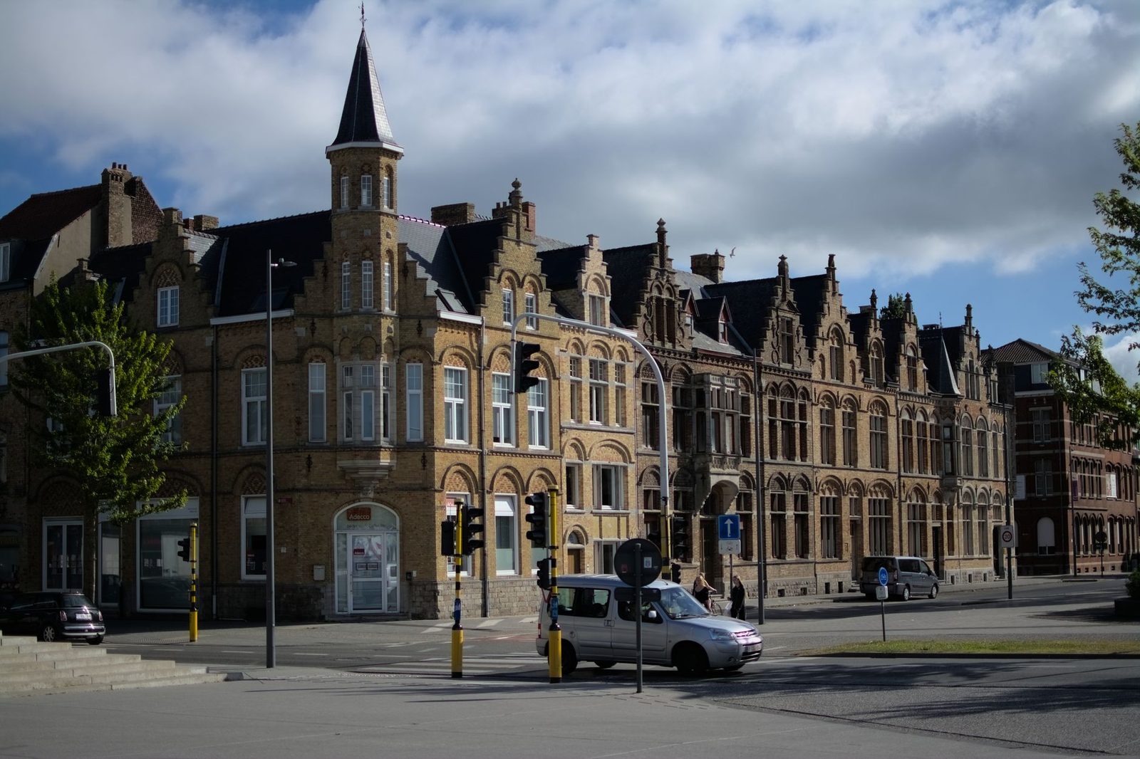 Classic Gothic-style buildings under a clear sky in Ypres, Belgium.