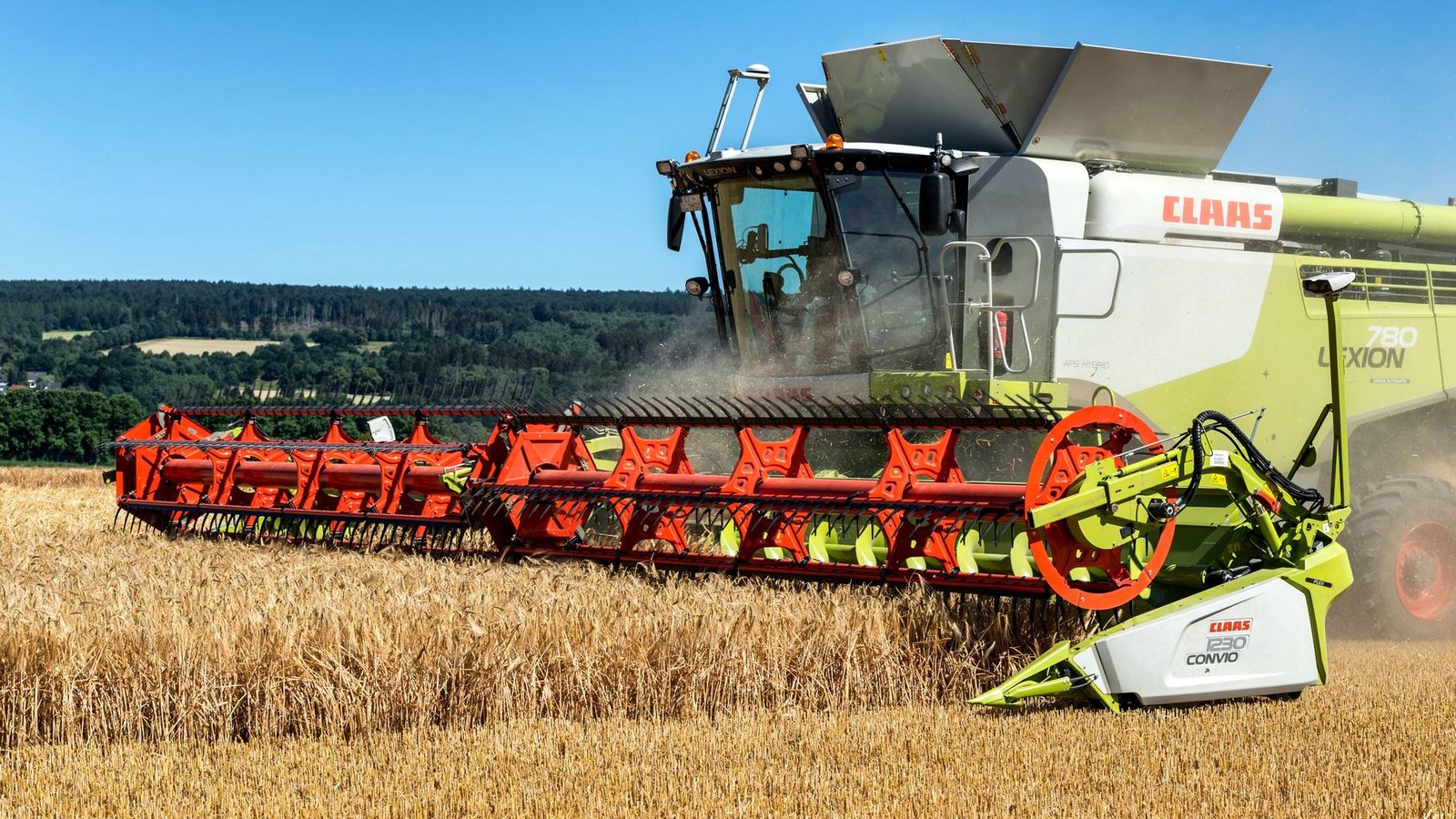 Combine harvester working in wheat fields of Höxter, Germany on a sunny day.