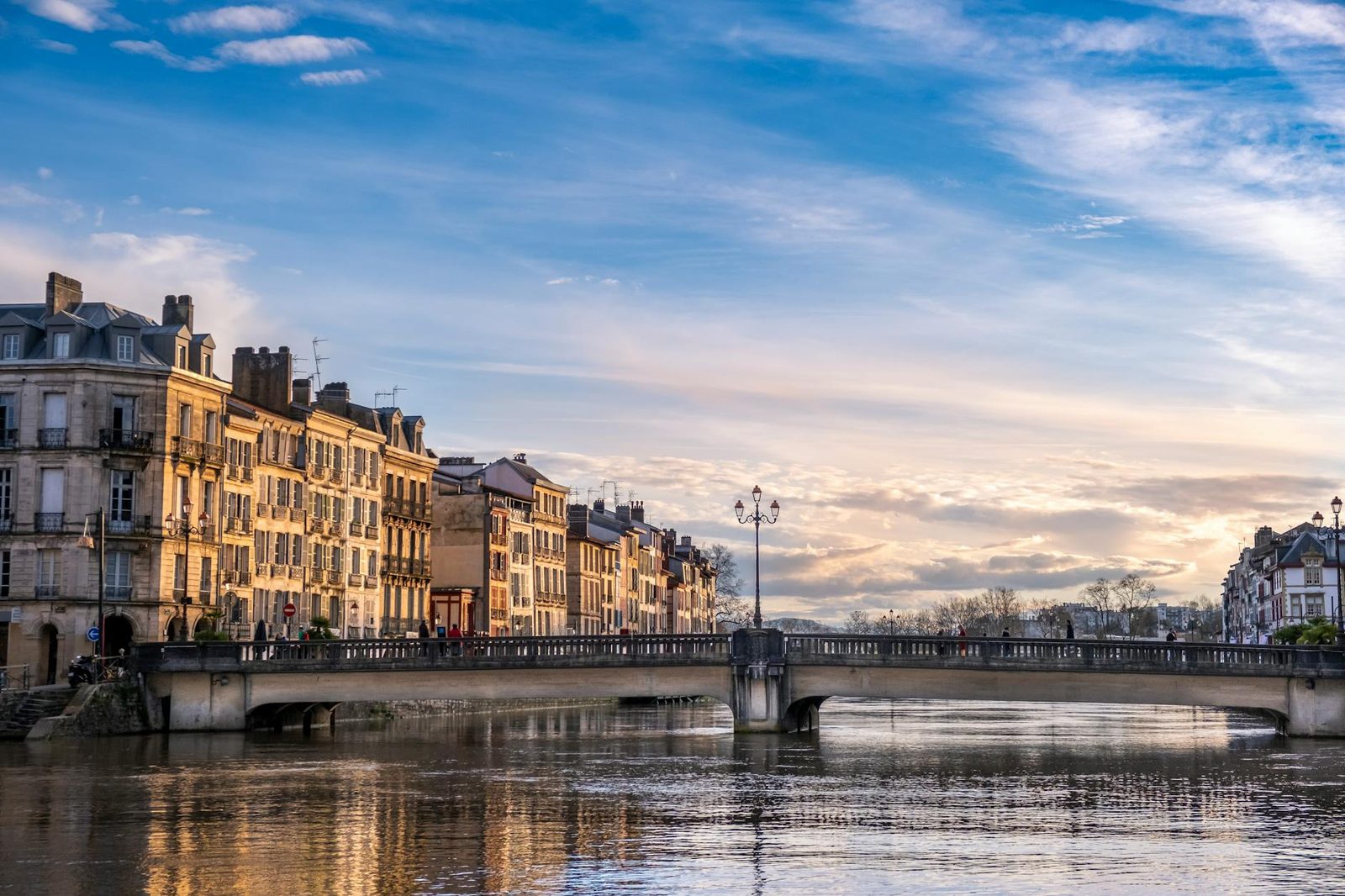 Beautiful view of a bridge over the river in Bayonne, Nouvelle-Aquitaine during sunset.