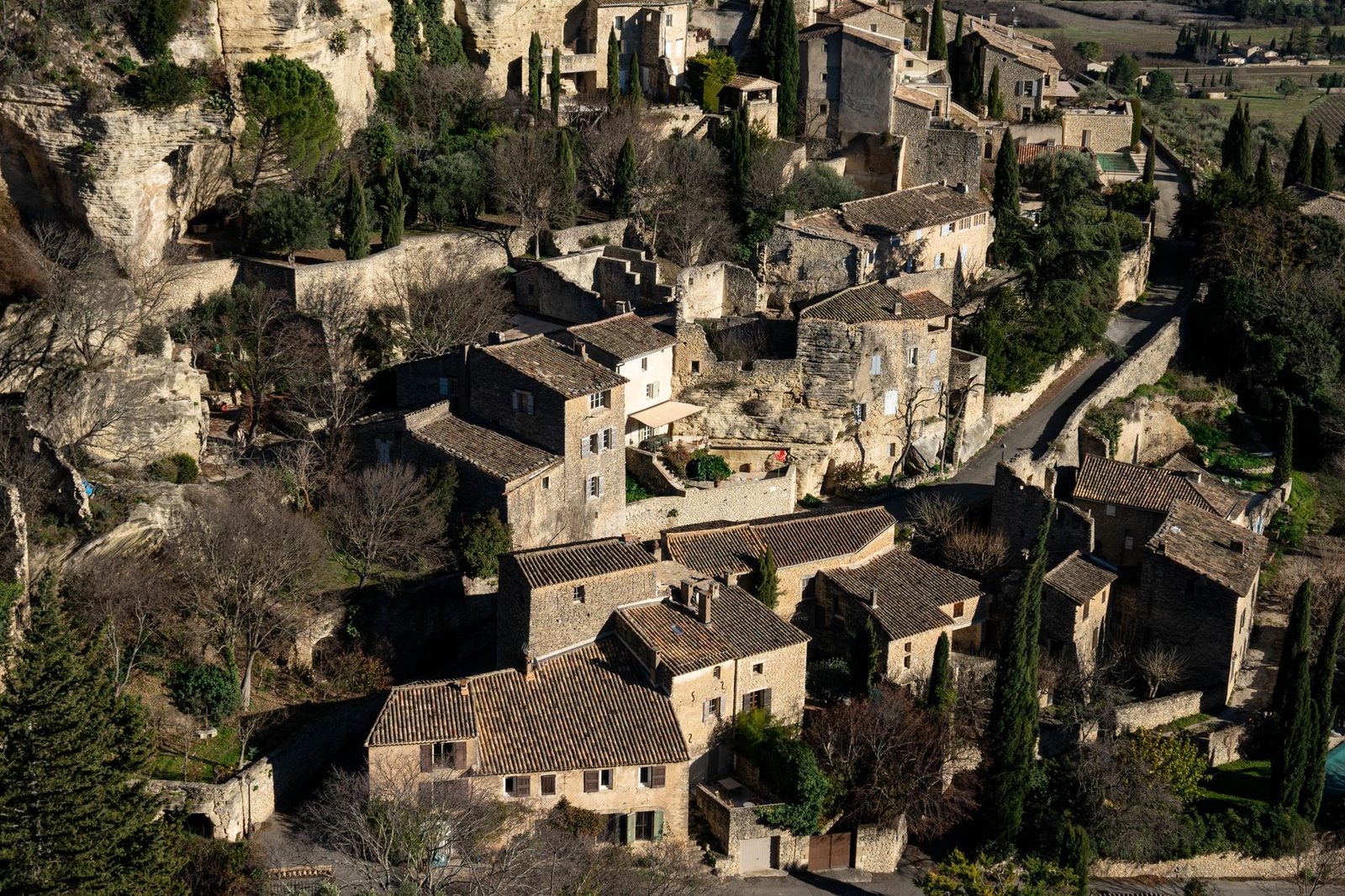Explore the picturesque village of Gordes, a historic gem in Provence with rustic stone houses and lush greenery.