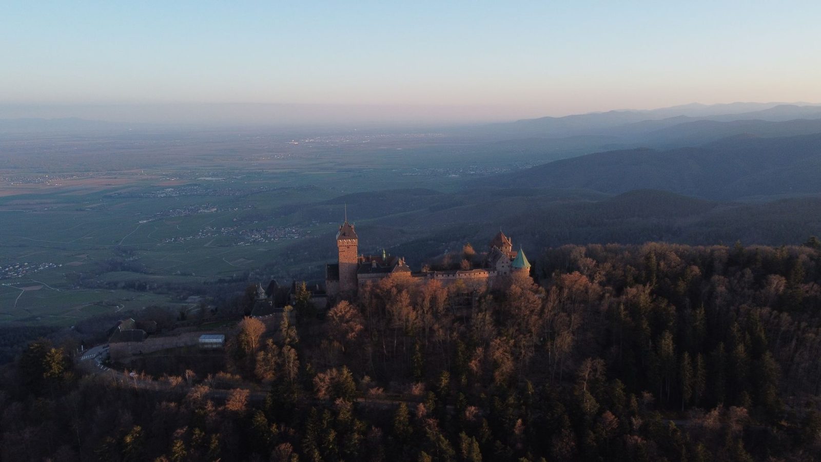Stunning aerial view of Haut-Kœnigsbourg Castle amidst autumn forests in Kintzheim, Grand Est, France.