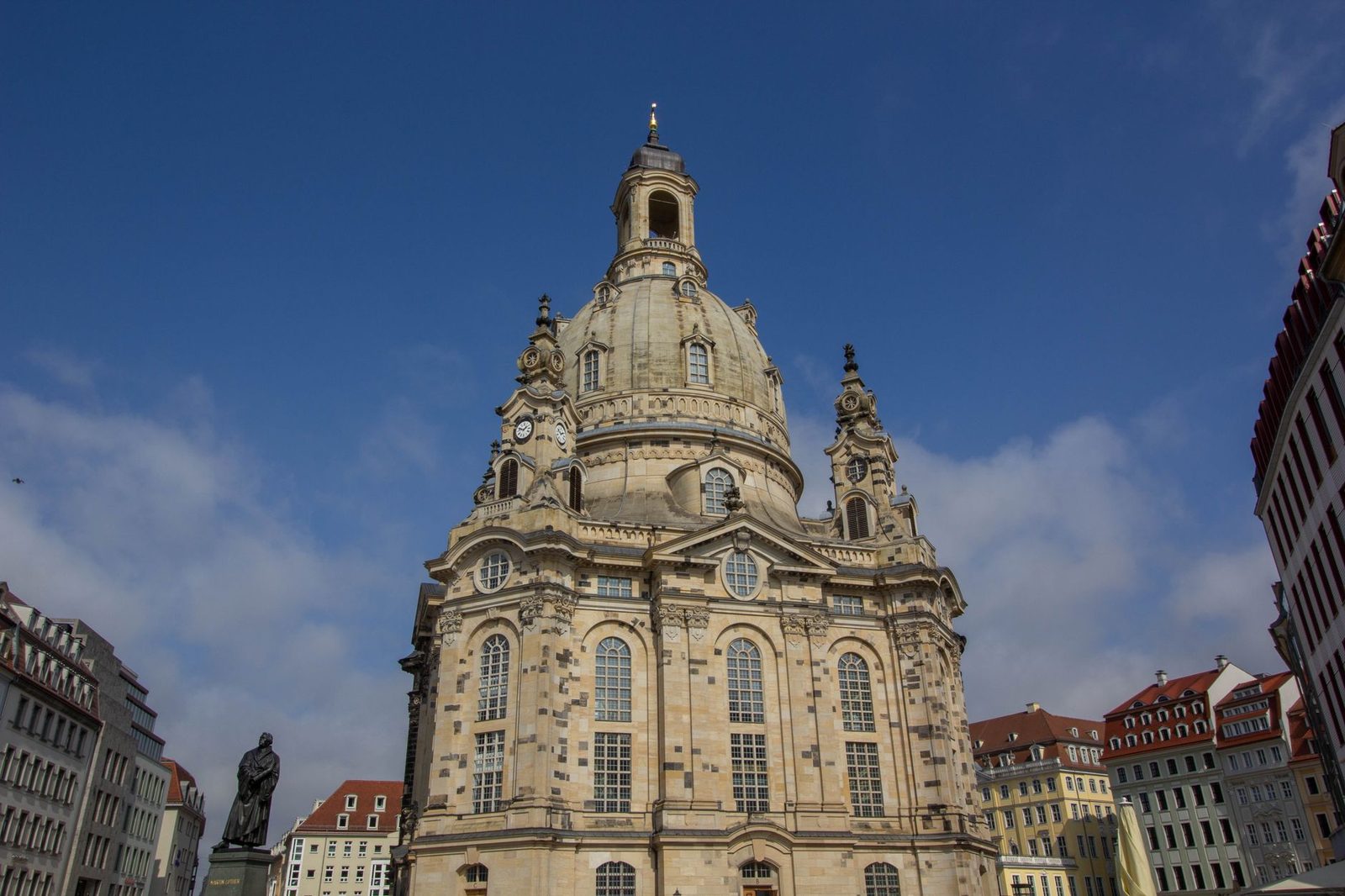 Majestic architecture of Dresden Frauenkirche under a clear blue sky.