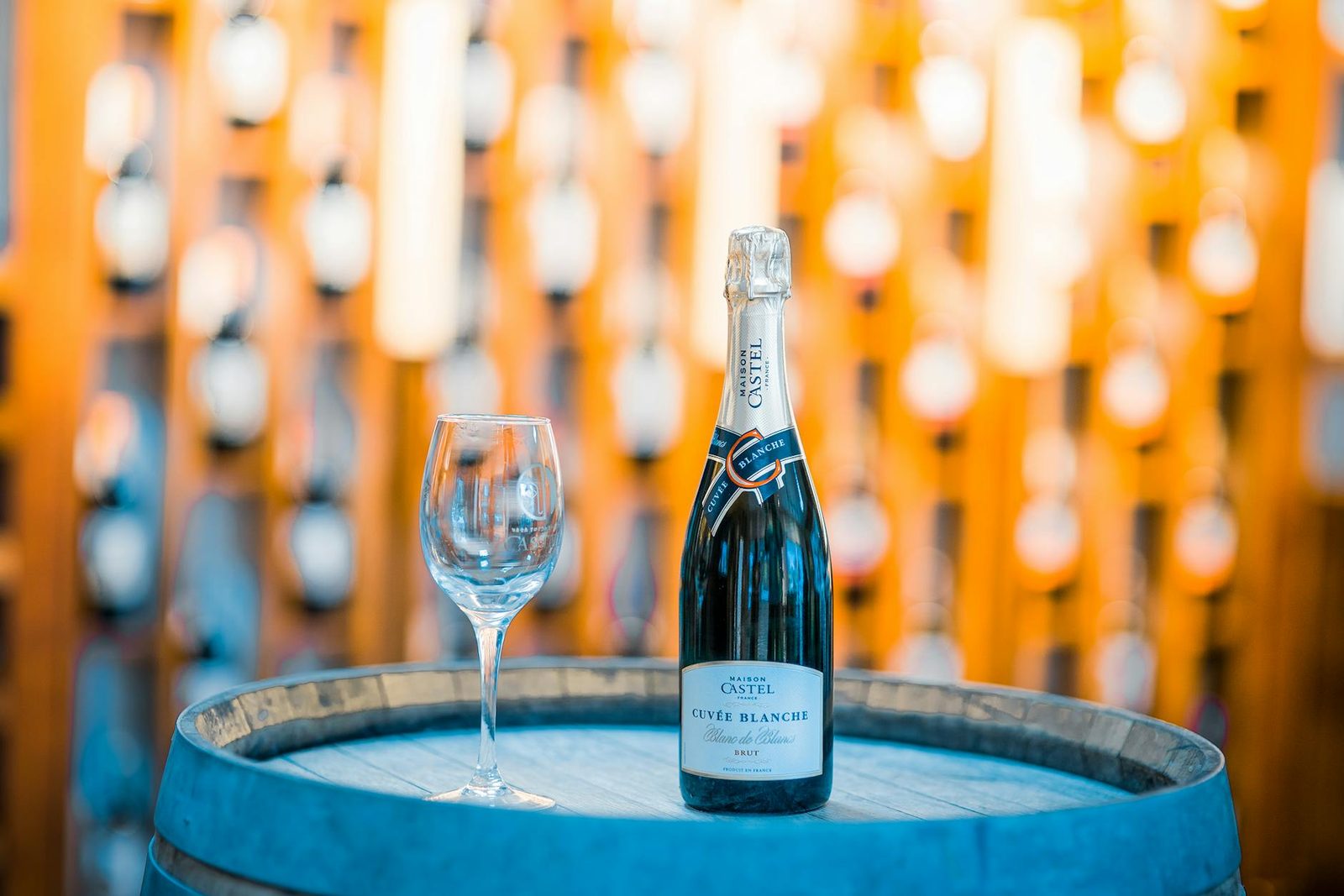 Champagne bottle and glass on a wooden barrel in a winery in Ethiopia, perfect for celebration themes.
