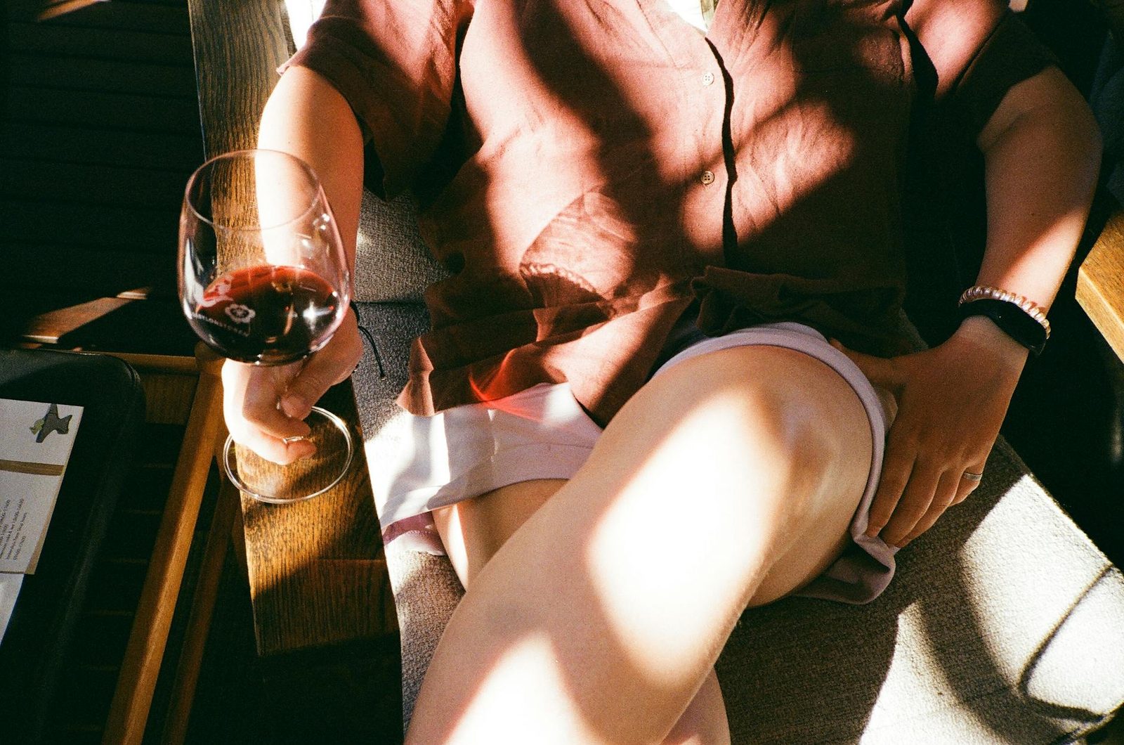 Person relaxing with a glass of red wine in Franschhoek, South Africa.